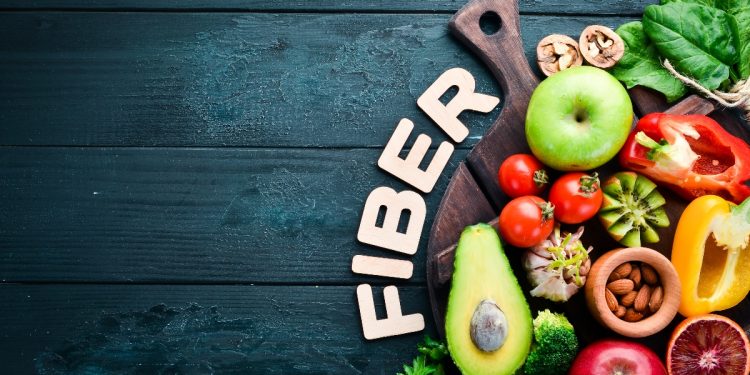 su base blu una scritta Fiber e una collezione di verdure e frutta miste