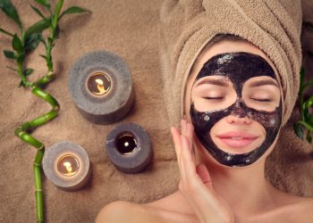 una donna rilassata con la black mask applicata sul viso