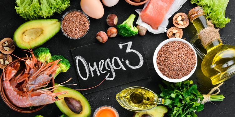 su sfondo nero alimenti come avocado, uova, semi di chia, gamberi e olio con al centro la scritta omega 3