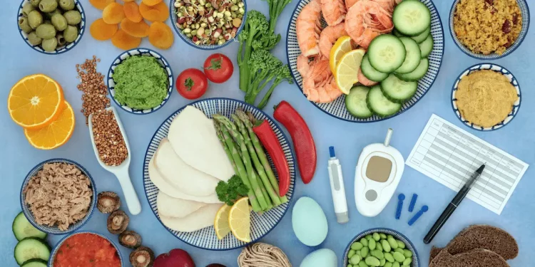 diversi alimenti su una tavola con accanto un apparecchio per misurare l'indice glicemico