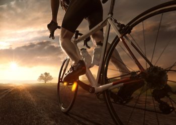 Un uomo che pedala al tramonto