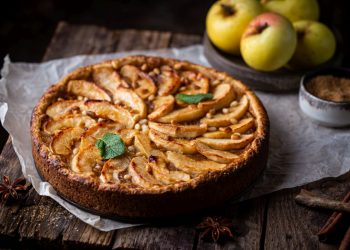 una torta di mela e ricotta, soffice su base di legno