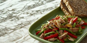 su tavolo di marmo da cucina piatto rettangolare verde con fagiolini con tonno e 2 fette di pane integrale